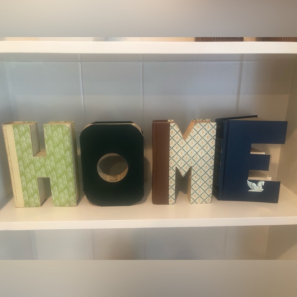 Anthropologie: Hand cut letters from Reader’s Digest books. Spells out “HOME.”